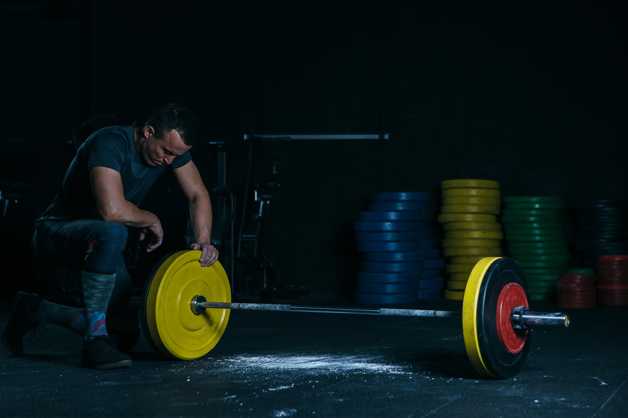 Exhausted male athlete with barbell