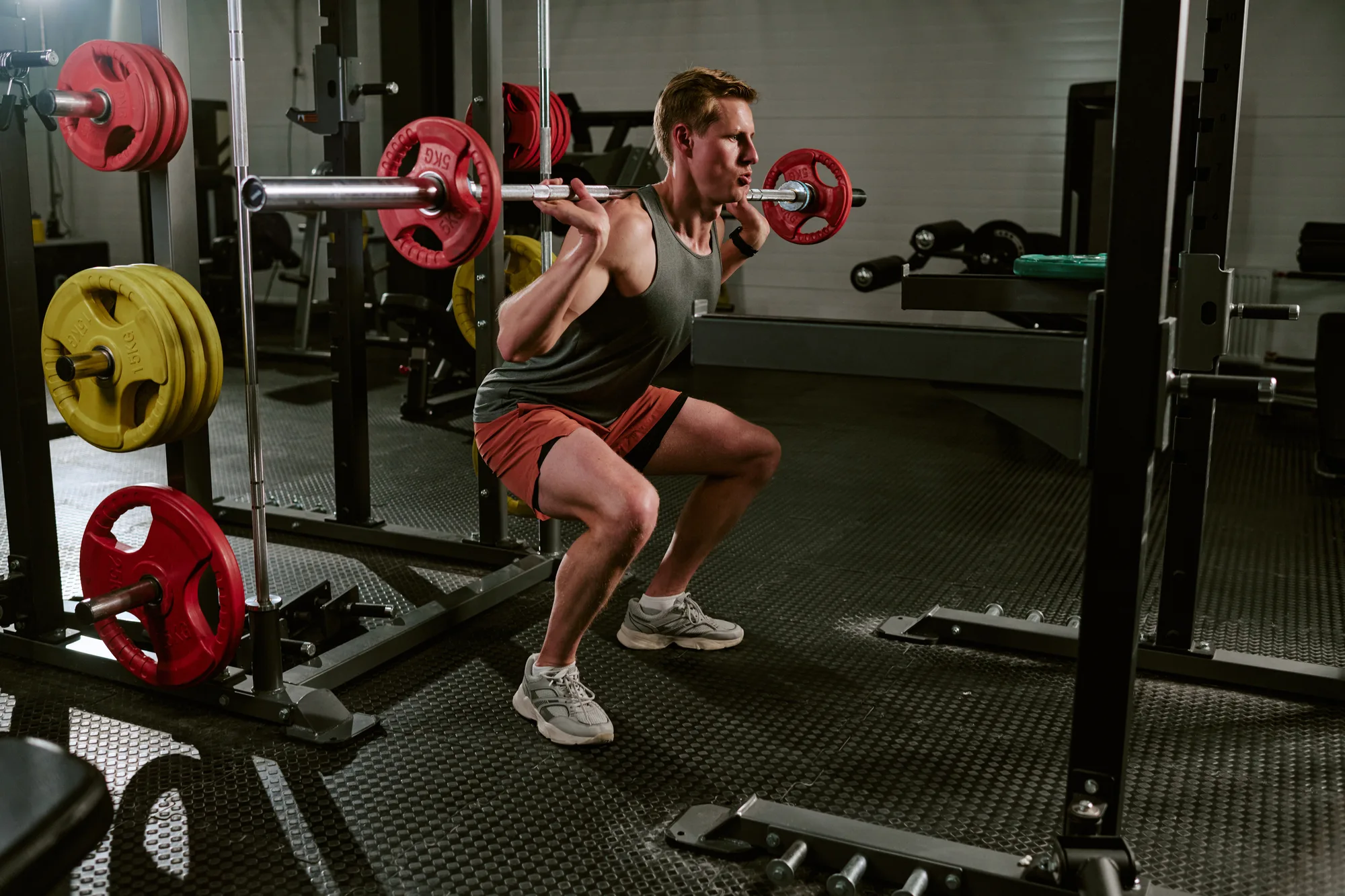 Male Athlete Training with Barbell Squats in Gym for Strength Gains